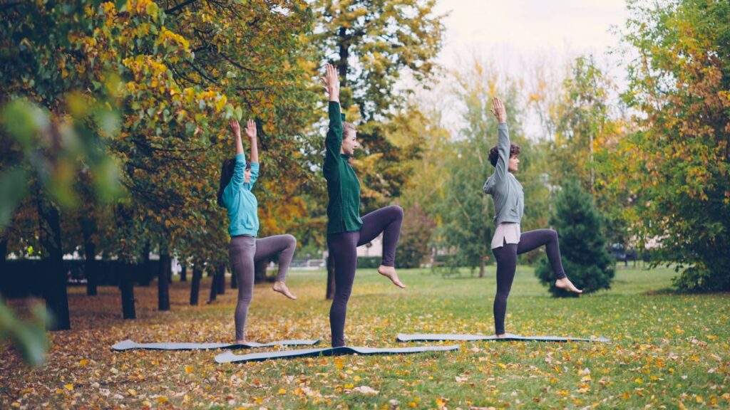 Women practicing yoga outdoors