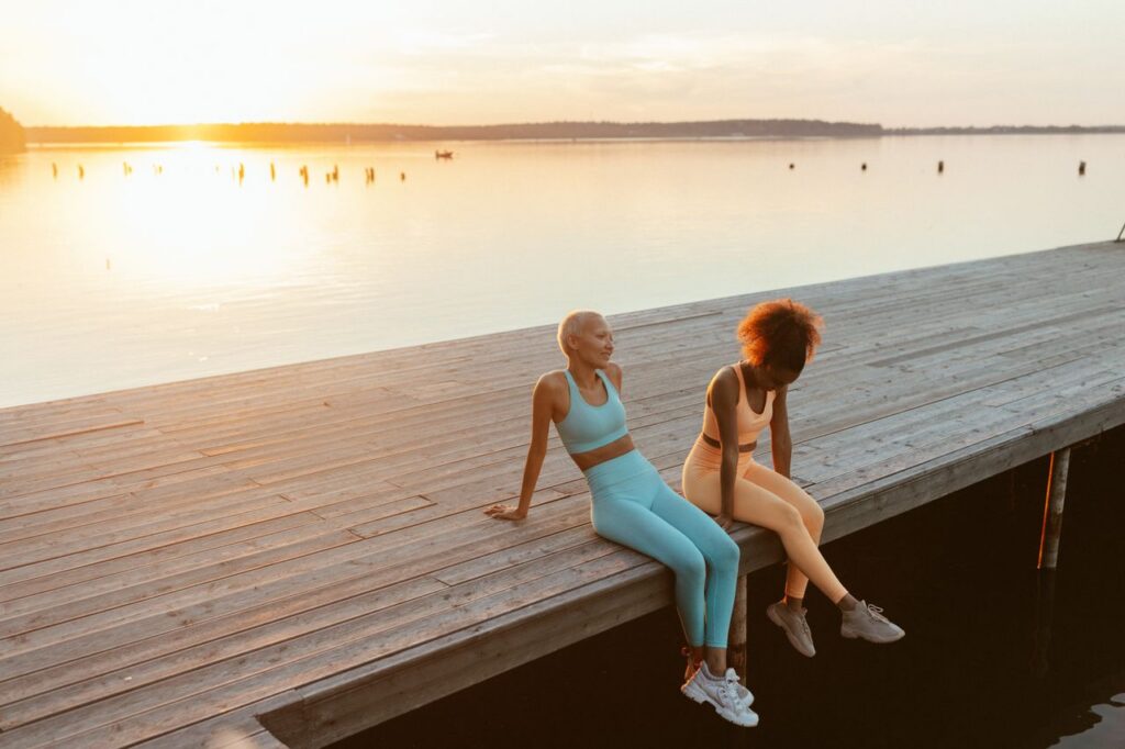 Two women relaxing outdoors at sunset