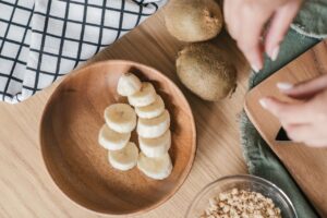 Top view of fresh banana slices with kiwis and oats, perfect for healthy eating inspiration.